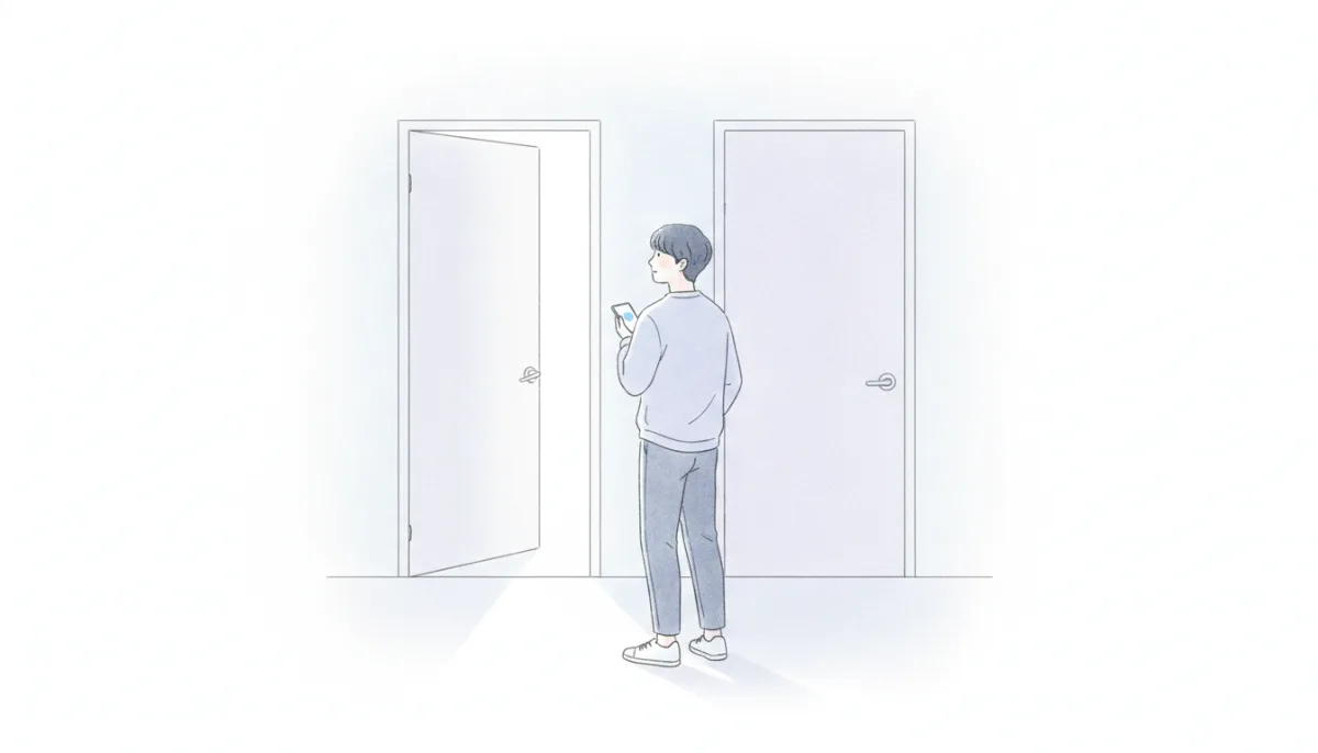 나란히 있는 두 문 중 살짝 열린 문을 바라보는 사람